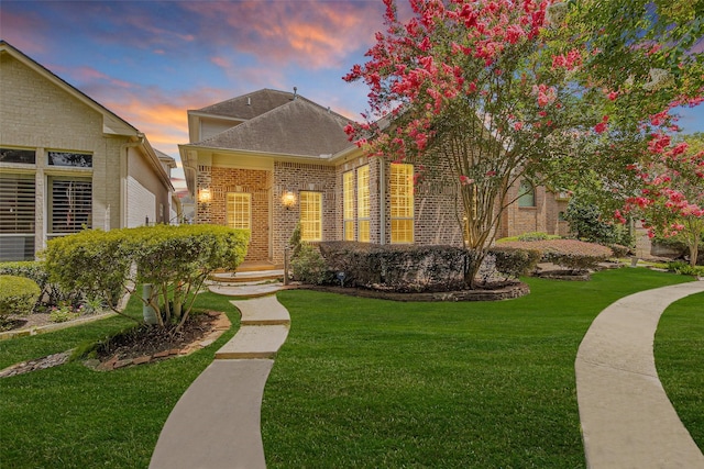 6616 Queensclub Dr, Houston, TX 77069 - view of front of house with brick siding, a yard, and roof with shingles