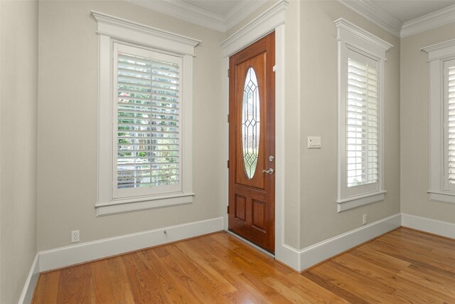 6616 Queensclub Dr, Houston, TX 77069 - entrance foyer featuring light wood-type flooring, healthy amount of natural light, and ornamental molding