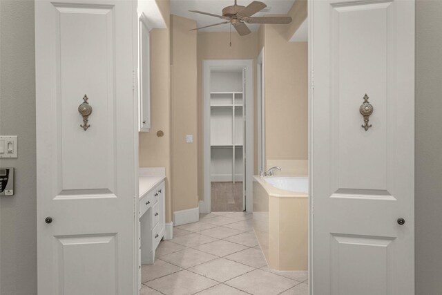 6616 Queensclub Dr, Houston, TX 77069 - full bath with a ceiling fan, a bath, tile patterned floors, vanity, and a spacious closet