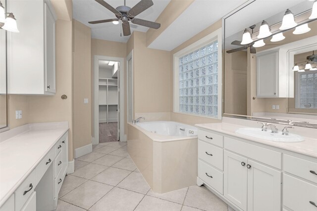 6616 Queensclub Dr, Houston, TX 77069 - bathroom featuring vanity, a ceiling fan, a garden tub, tile patterned flooring, and a spacious closet