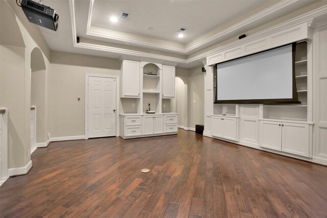 6616 Queensclub Dr, Houston, TX 77069 - home theater featuring a tray ceiling, arched walkways, dark wood-style flooring, recessed lighting, and crown molding