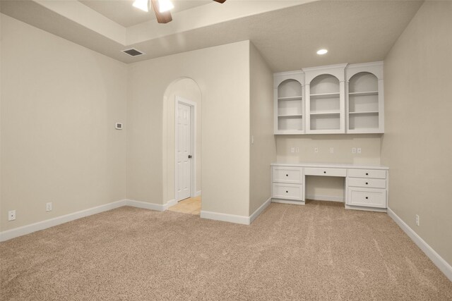 6616 Queensclub Dr, Houston, TX 77069 - unfurnished office with light carpet, ceiling fan, arched walkways, recessed lighting, and built in desk