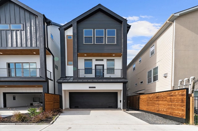 5505 Kansas St, Houston, TX 77007 - contemporary house featuring a balcony, an attached garage, concrete driveway, and board and batten siding