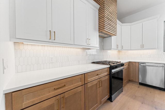 5505 Kansas St, Houston, TX 77007 - kitchen featuring stainless steel dishwasher, gas stove, light wood finished floors, backsplash, and light countertops
