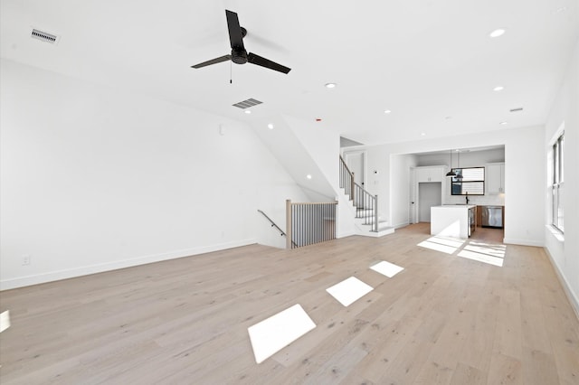 5505 Kansas St, Houston, TX 77007 - unfurnished living room featuring light wood-type flooring, ceiling fan, and recessed lighting