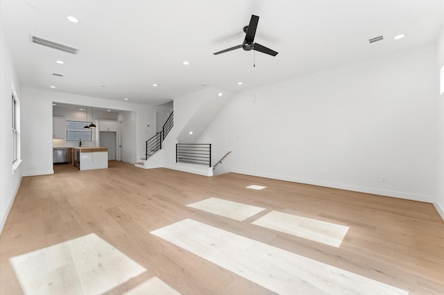 5505 Kansas St, Houston, TX 77007 - unfurnished living room featuring recessed lighting, light wood-style flooring, a ceiling fan, and stairway