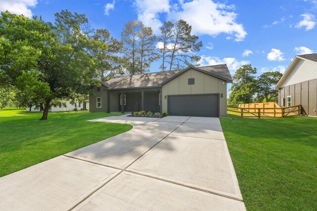 256 Davis Bend Rd, Alvin, TX 77511 - ranch-style house with a garage and concrete driveway