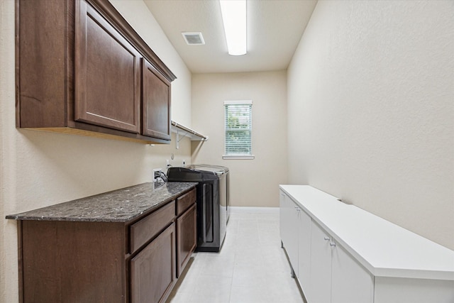 4906 Lodge Lake Dr, Fulshear, TX 77441 - laundry area with cabinet space, independent washer and dryer, and light tile patterned flooring