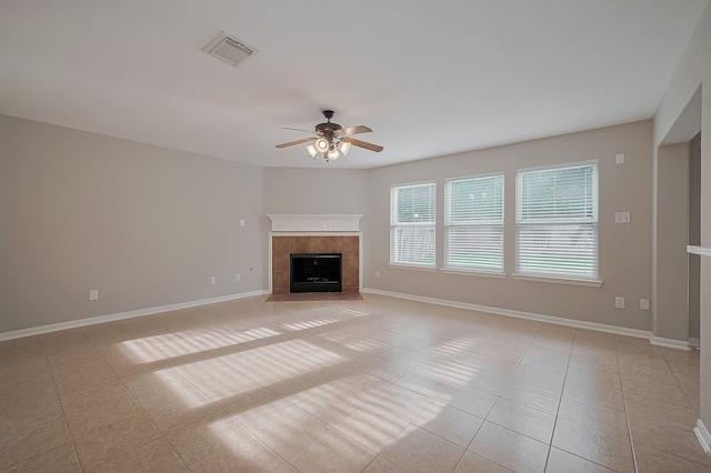 9714 Angleside Ln, Sugar Land, TX 77498 - unfurnished living room featuring ceiling fan, a tiled fireplace, and light tile patterned flooring