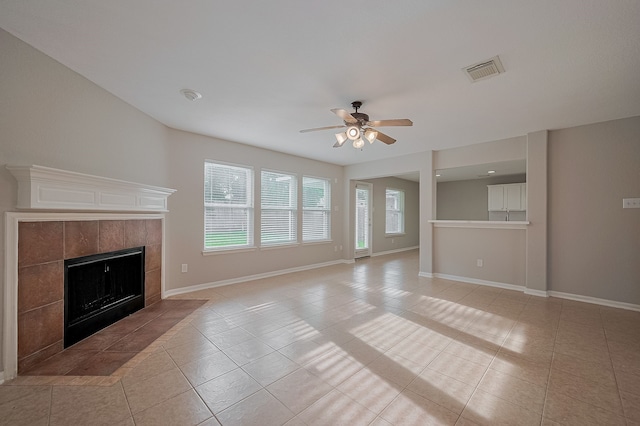 9714 Angleside Ln, Sugar Land, TX 77498 - unfurnished living room with light tile patterned flooring, a tile fireplace, and ceiling fan