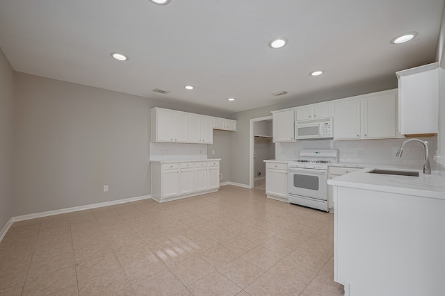 9714 Angleside Ln, Sugar Land, TX 77498 - kitchen featuring white appliances, recessed lighting, decorative backsplash, white cabinetry, and light countertops
