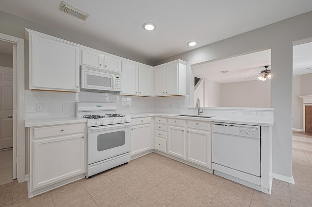 9714 Angleside Ln, Sugar Land, TX 77498 - kitchen with white appliances, light countertops, ceiling fan, a peninsula, and white cabinets