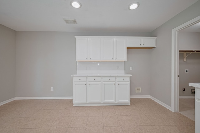 9714 Angleside Ln, Sugar Land, TX 77498 - kitchen with light countertops, white cabinets, light tile patterned floors, and recessed lighting