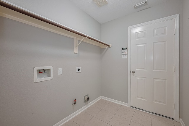 9714 Angleside Ln, Sugar Land, TX 77498 - washroom with gas dryer hookup, hookup for a washing machine, light tile patterned floors, and electric dryer hookup