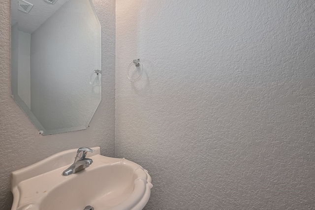 9714 Angleside Ln, Sugar Land, TX 77498 - bathroom featuring a sink and a textured wall
