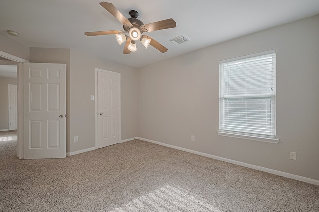 9714 Angleside Ln, Sugar Land, TX 77498 - unfurnished bedroom with multiple windows, carpet, and a ceiling fan