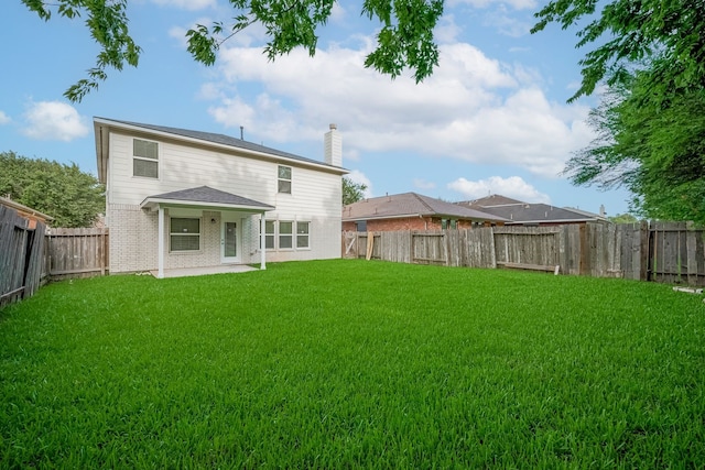 9714 Angleside Ln, Sugar Land, TX 77498 - rear view of house featuring a chimney, a fenced backyard, and brick siding