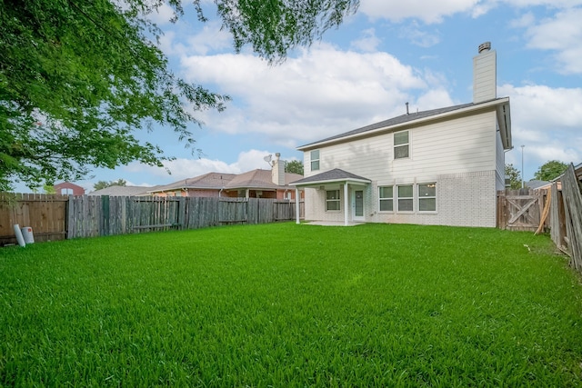 9714 Angleside Ln, Sugar Land, TX 77498 - back of property featuring brick siding, a fenced backyard, and a chimney