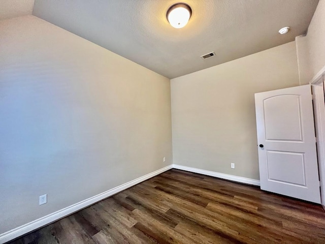 22223 Slate Oaks Ln, Richmond, TX 77469 - empty room featuring dark wood finished floors, a smoke detector, and lofted ceiling