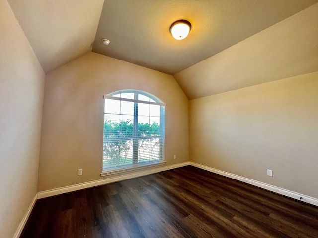 22223 Slate Oaks Ln, Richmond, TX 77469 - spare room featuring vaulted ceiling, dark wood-style flooring, and a smoke detector