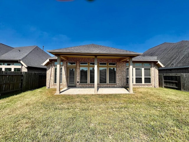 22223 Slate Oaks Ln, Richmond, TX 77469 - back of property with brick siding, a fenced backyard, and a patio