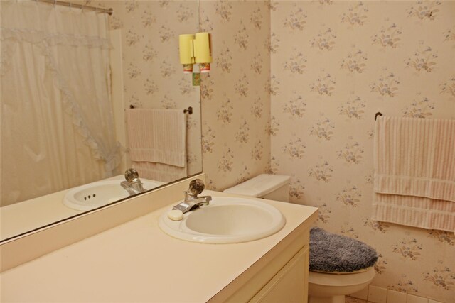 216 N St, Columbus, TX 78934 - full bathroom with wallpapered walls, vanity, tile patterned flooring, and curtained shower