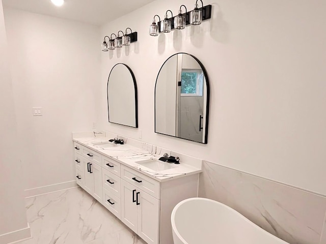6747 Liverpool St, Houston, TX 77021 - bathroom with a soaking tub, double vanity, and marble look tile flooring