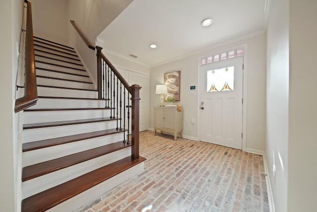 2200 Potomac Dr, Houston, TX 77057 - foyer with brick floors, ornamental molding, stairway, and recessed lighting