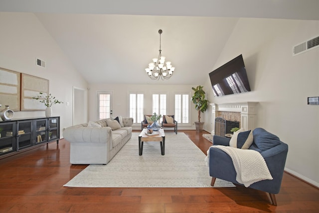 2200 Potomac Dr, Houston, TX 77057 - living area featuring high vaulted ceiling, a chandelier, dark wood finished floors, and a fireplace with raised hearth