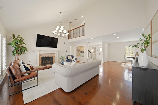 2200 Potomac Dr, Houston, TX 77057 - living room featuring dark wood-style floors, a chandelier, a brick fireplace, and high vaulted ceiling