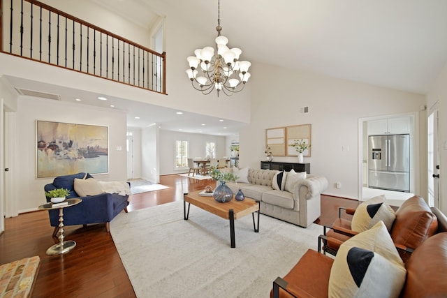 2200 Potomac Dr, Houston, TX 77057 - living room featuring wood finished floors, high vaulted ceiling, and a chandelier