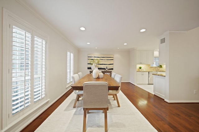 2200 Potomac Dr, Houston, TX 77057 - dining space with dark wood-style flooring, ornamental molding, and recessed lighting