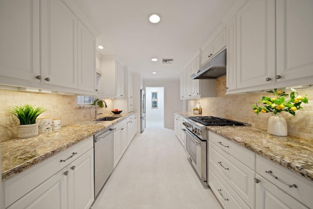 2200 Potomac Dr, Houston, TX 77057 - kitchen featuring stainless steel appliances, under cabinet range hood, white cabinets, recessed lighting, and light stone counters