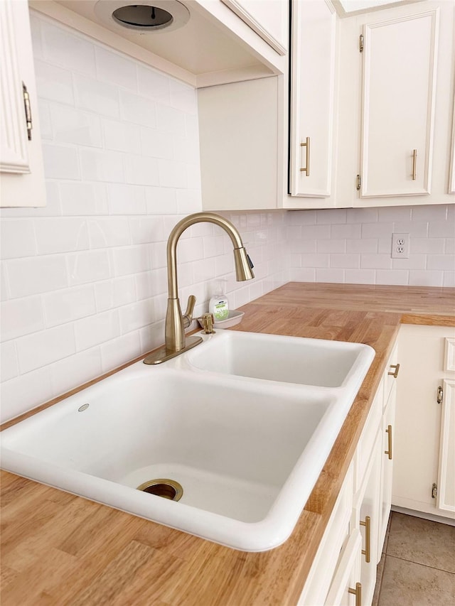 4040 San Felipe St Unit 135, Houston, TX 77027 - kitchen view of white cabinetry and decorative backsplash