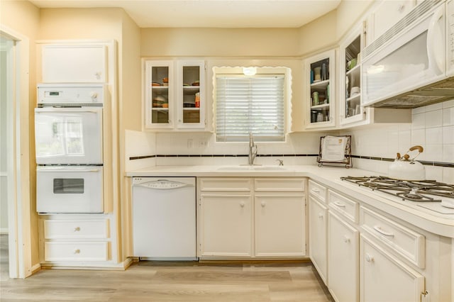 11823 Blair Meadow Dr, Meadows Place, TX 77477 - kitchen with white appliances, decorative backsplash, and light countertops