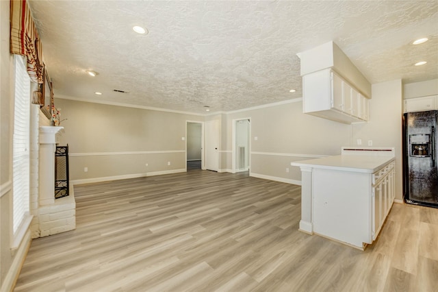 11823 Blair Meadow Dr, Meadows Place, TX 77477 - kitchen featuring black refrigerator with ice dispenser, white cabinetry, light countertops, a textured ceiling, and recessed lighting