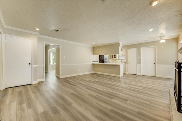 11823 Blair Meadow Dr, Meadows Place, TX 77477 - unfurnished living room featuring a textured ceiling, light wood finished floors, crown molding, ceiling fan, and recessed lighting