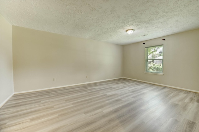 11823 Blair Meadow Dr, Meadows Place, TX 77477 - empty room with light wood-style floors and a textured ceiling