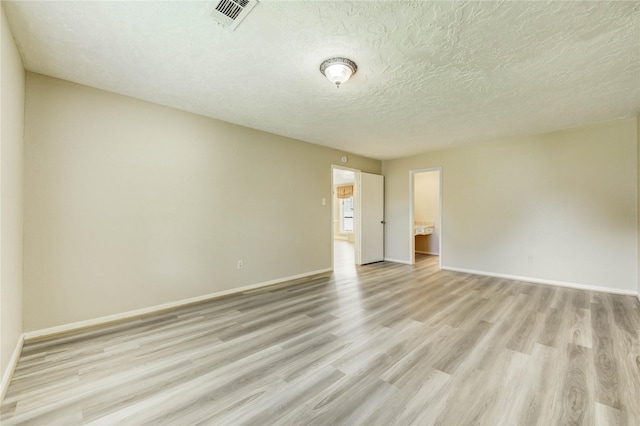 11823 Blair Meadow Dr, Meadows Place, TX 77477 - unfurnished room with light wood finished floors and a textured ceiling