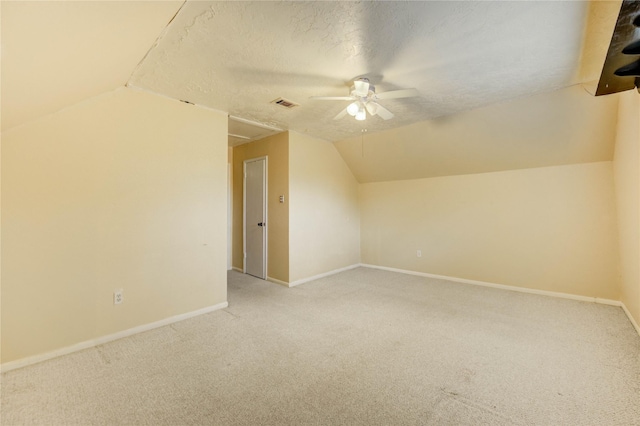 11823 Blair Meadow Dr, Meadows Place, TX 77477 - bonus room with light colored carpet, a ceiling fan, lofted ceiling, and a textured ceiling