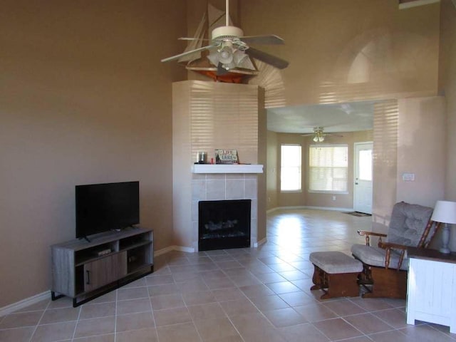 70 Lakeside, Trinity, TX 75862 - living area with a ceiling fan, light tile patterned floors, a tiled fireplace, and a towering ceiling