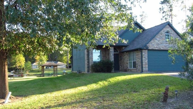70 Lakeside, Trinity, TX 75862 - view of side of home with a yard, an attached garage, and brick siding