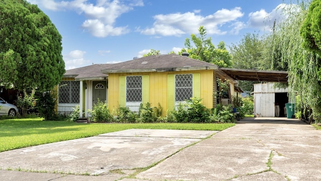 1314 Lawrence Ave, Pasadena, TX 77506 - view of front of property with concrete driveway, a front yard, and an attached carport
