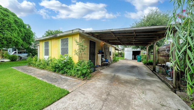 1314 Lawrence Ave, Pasadena, TX 77506 - view of parking / parking lot with driveway, a storage unit, and an attached carport