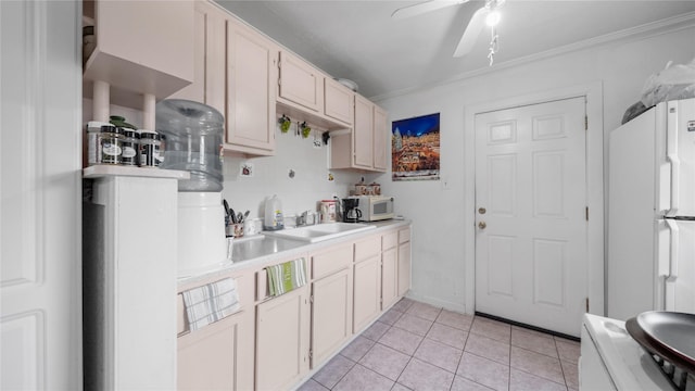 1314 Lawrence Ave, Pasadena, TX 77506 - kitchen featuring white appliances, light countertops, crown molding, a ceiling fan, and light tile patterned floors