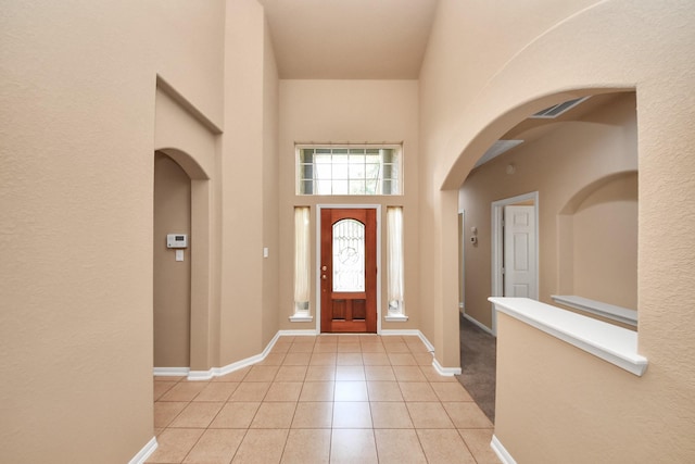 30041 Willow Walk Ln, Brookshire, TX 77423 - foyer with arched walkways, light tile patterned floors, and a towering ceiling