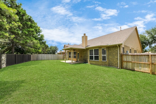 30041 Willow Walk Ln, Brookshire, TX 77423 - rear view of property featuring a chimney, a fenced backyard, brick siding, a patio area, and a shingled roof