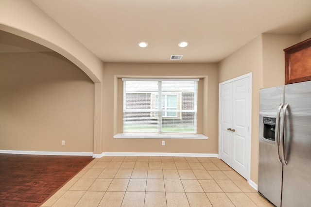 30041 Willow Walk Ln, Brookshire, TX 77423 - kitchen with stainless steel fridge with ice dispenser, arched walkways, recessed lighting, and light tile patterned floors