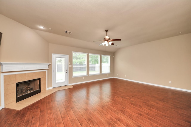 30041 Willow Walk Ln, Brookshire, TX 77423 - unfurnished living room with a ceiling fan, a tile fireplace, hardwood / wood-style flooring, vaulted ceiling, and recessed lighting