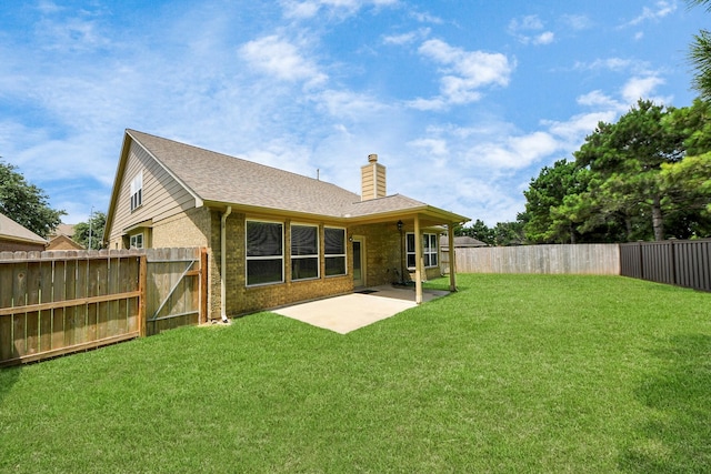 30041 Willow Walk Ln, Brookshire, TX 77423 - back of property with a chimney, a fenced backyard, a patio, and brick siding